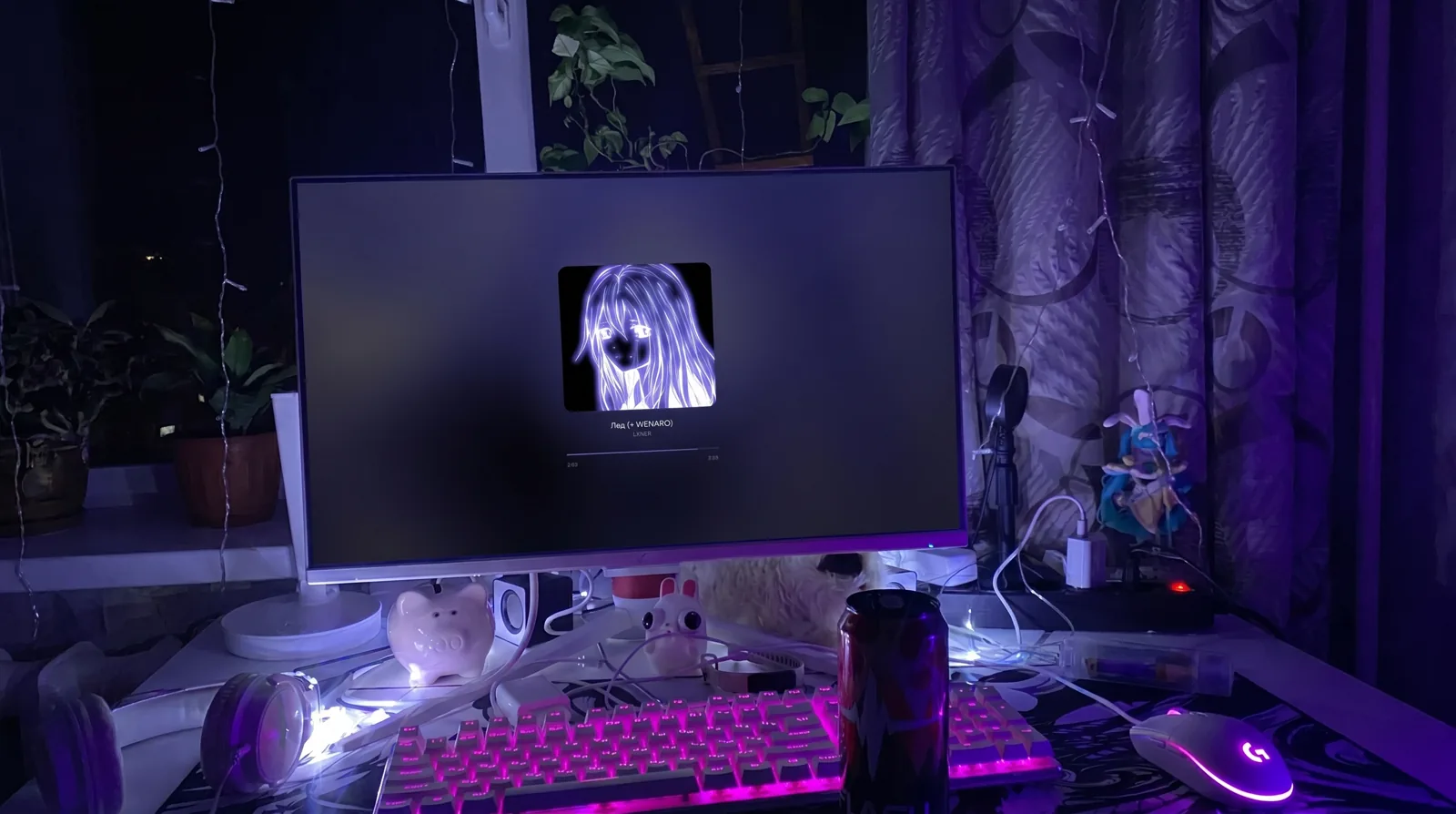Purple-lit RGB desk setup with the player on screen